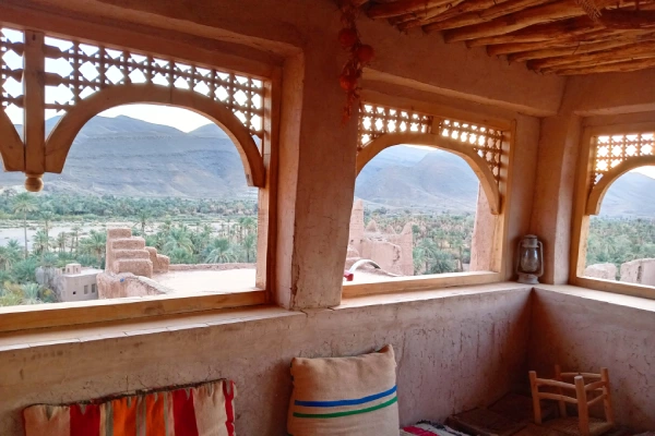 View of Kasbah Tamnougalt surrounded by palm trees in the Draa Valley